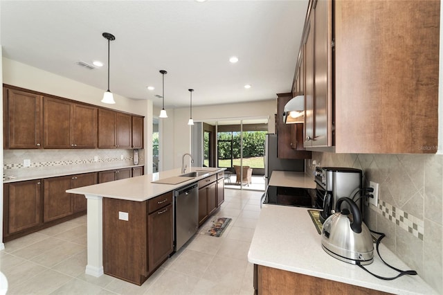 kitchen featuring tasteful backsplash, dishwasher, an island with sink, pendant lighting, and light tile patterned floors