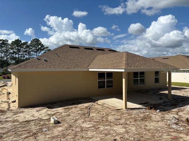 back of property with a patio