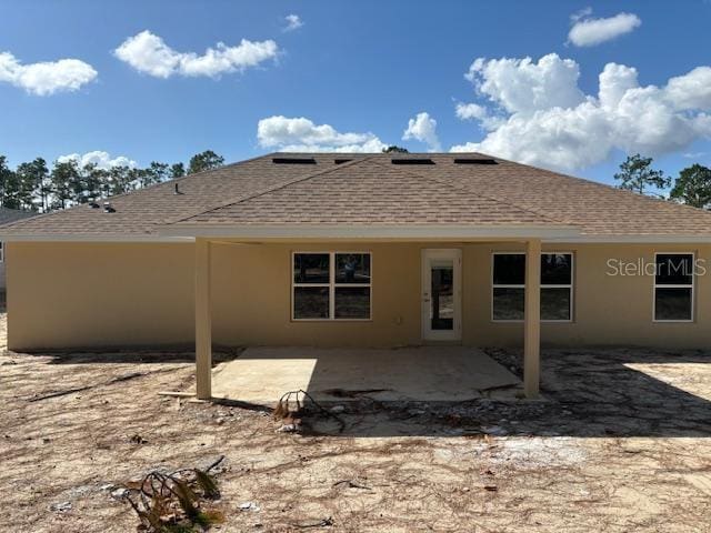 back of house with a patio