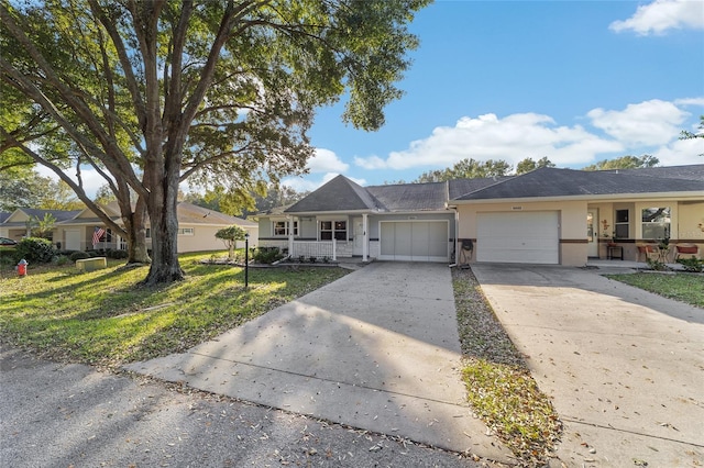 ranch-style house with covered porch, a front lawn, and a garage