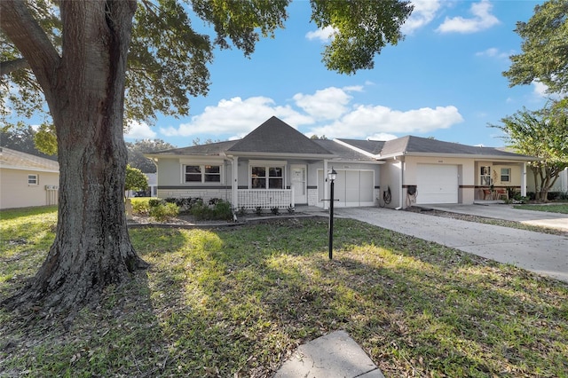 single story home with a front yard, covered porch, and a garage