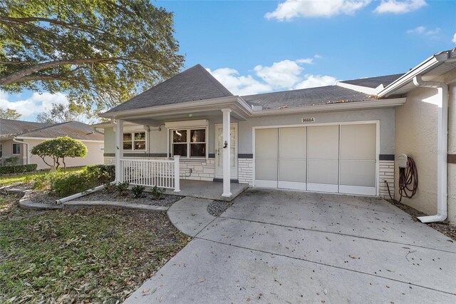 view of front facade with covered porch and a garage