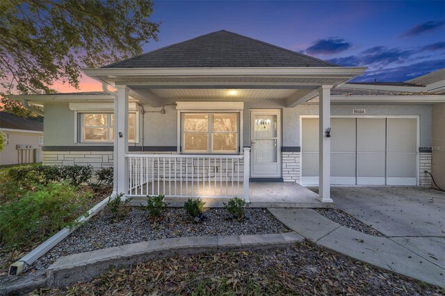 view of front of home featuring covered porch and a garage