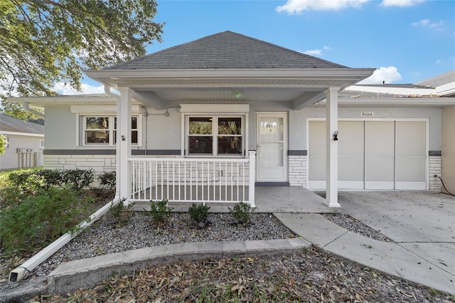 exterior space featuring covered porch and a garage