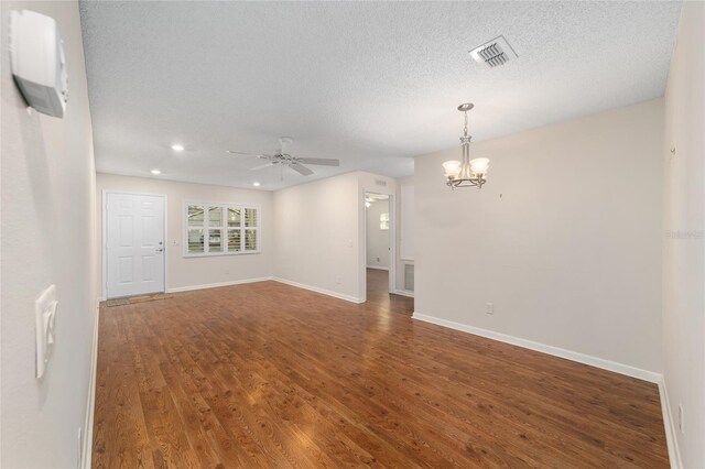 unfurnished room featuring a textured ceiling, ceiling fan with notable chandelier, and hardwood / wood-style floors