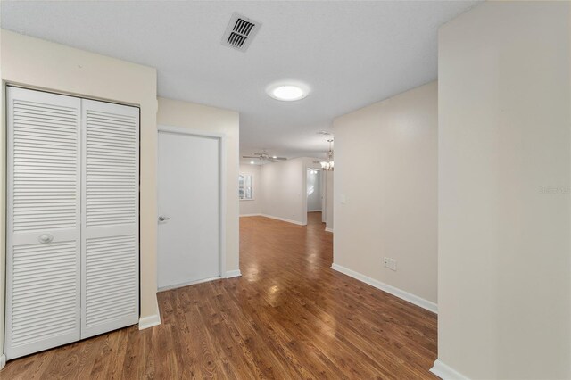 hallway with hardwood / wood-style flooring