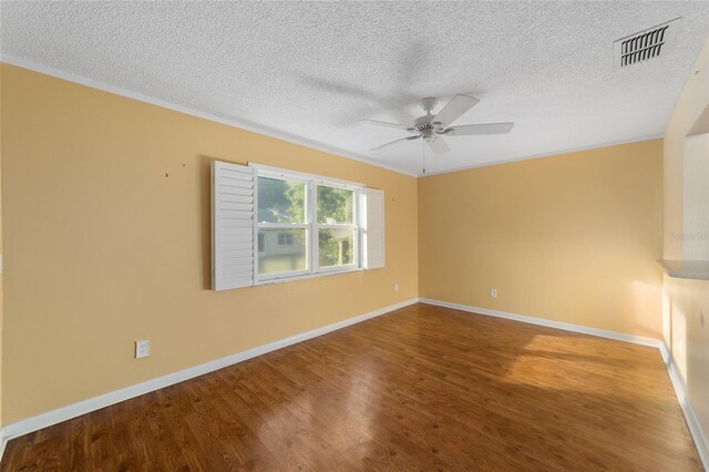 unfurnished room with crown molding, a textured ceiling, and hardwood / wood-style floors