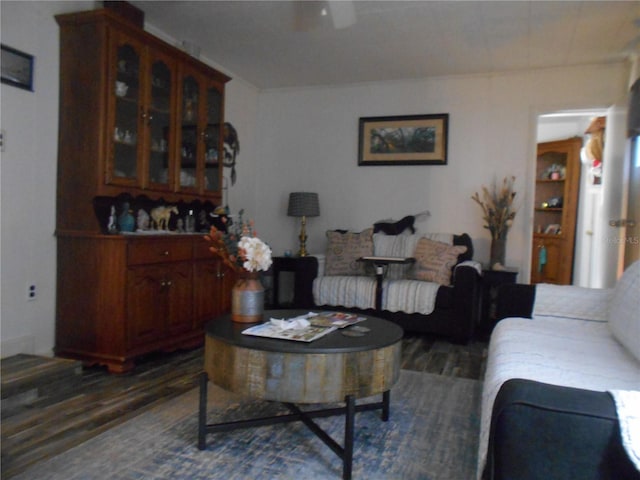 living room featuring dark wood-type flooring and ceiling fan