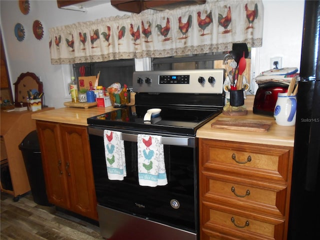 kitchen featuring dark wood-type flooring and electric range