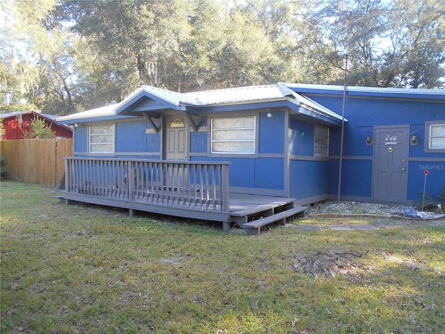 view of front of property with a deck and a front yard