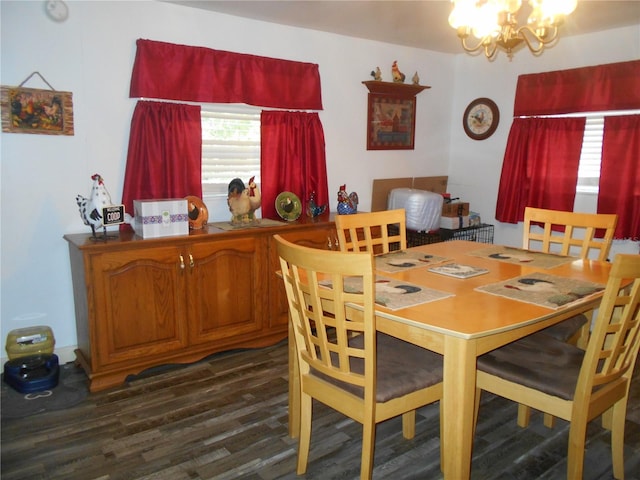 dining area featuring a notable chandelier and dark hardwood / wood-style flooring