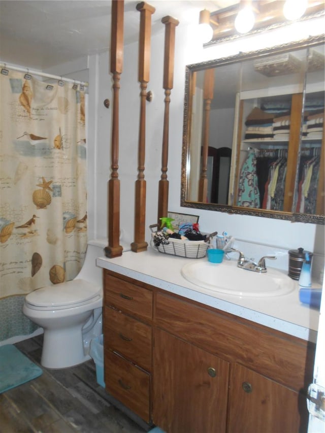 bathroom with vanity, toilet, a shower with curtain, and hardwood / wood-style floors