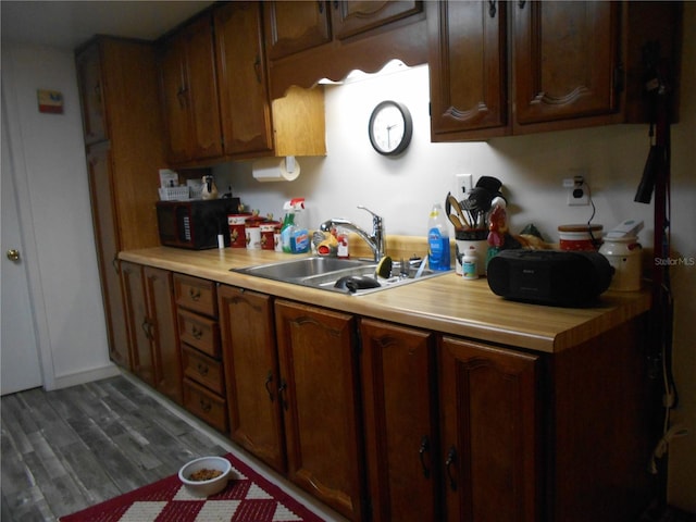 kitchen with sink and hardwood / wood-style floors