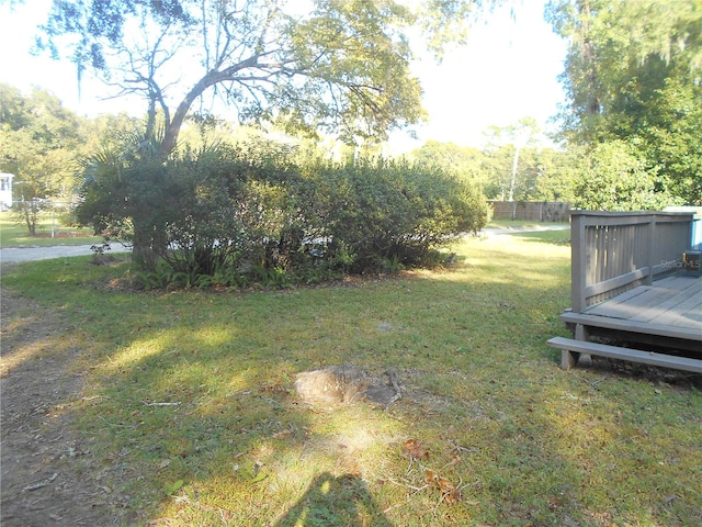 view of yard with a wooden deck