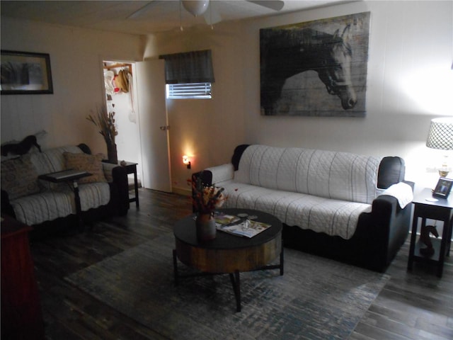 living room featuring ceiling fan and dark hardwood / wood-style floors