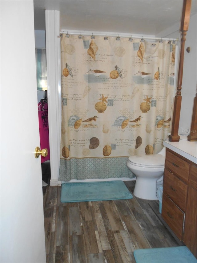 bathroom with vanity, a shower with curtain, hardwood / wood-style flooring, and toilet