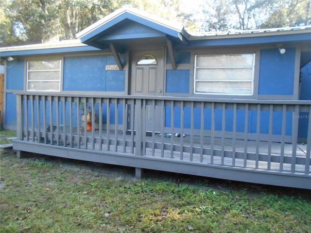 back of property with a wooden deck