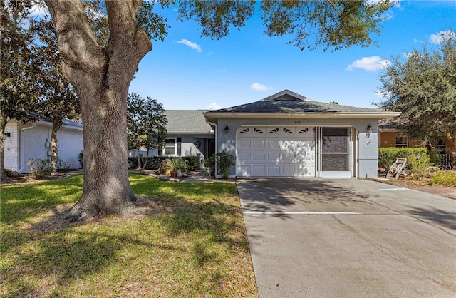 ranch-style house featuring a front yard and a garage