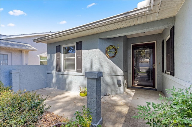 entrance to property with a patio