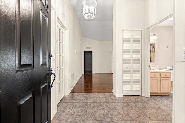 foyer featuring a chandelier and light hardwood / wood-style flooring