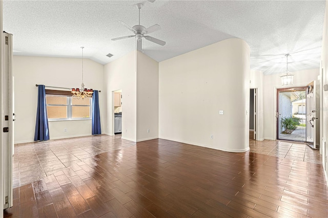 unfurnished living room with a textured ceiling, a wealth of natural light, and dark hardwood / wood-style flooring