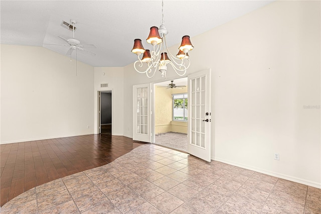 unfurnished room with an inviting chandelier, french doors, wood-type flooring, and vaulted ceiling