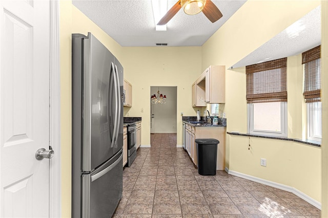 kitchen featuring sink, appliances with stainless steel finishes, a textured ceiling, and ceiling fan