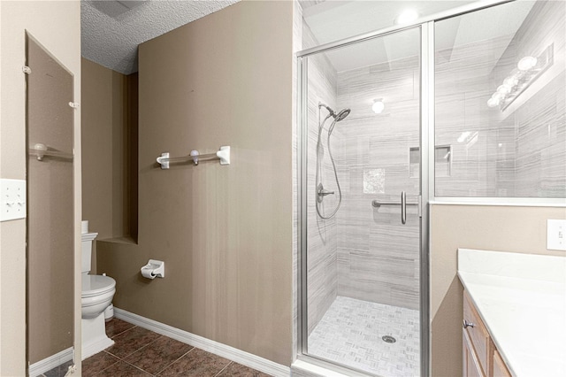 bathroom with a shower with door, a textured ceiling, toilet, tile patterned floors, and vanity