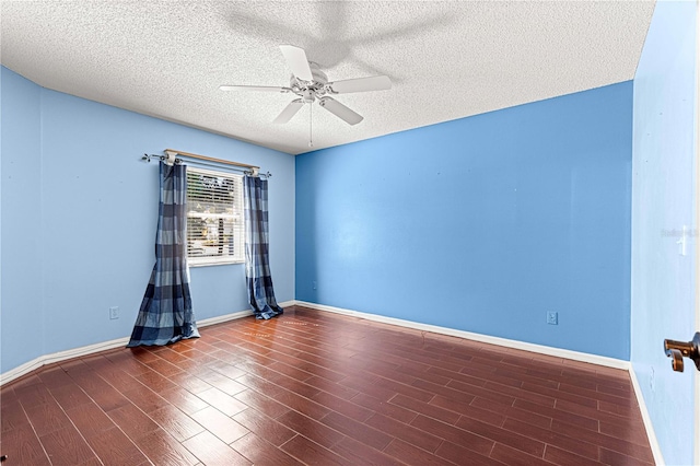 spare room featuring ceiling fan, a textured ceiling, and dark hardwood / wood-style floors