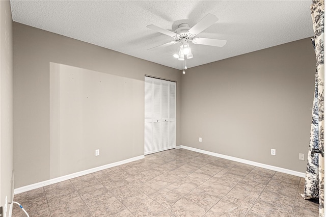 empty room featuring ceiling fan and a textured ceiling