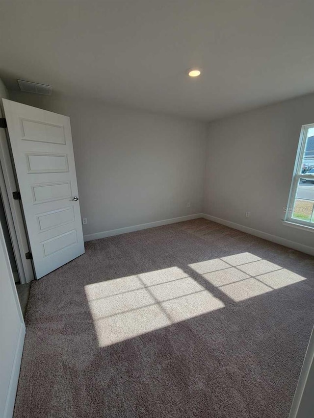 unfurnished room featuring carpet floors