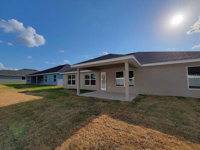 rear view of property with a patio area and a lawn