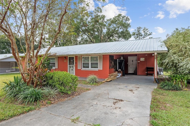 2810 SE 8th St, Ocala, FL 34471 - ranch-style home featuring concrete driveway, metal roof, and an attached carport