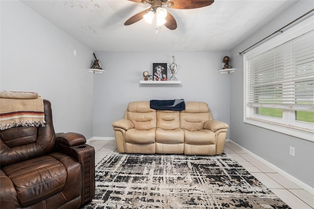 tiled living room featuring a textured ceiling and ceiling fan