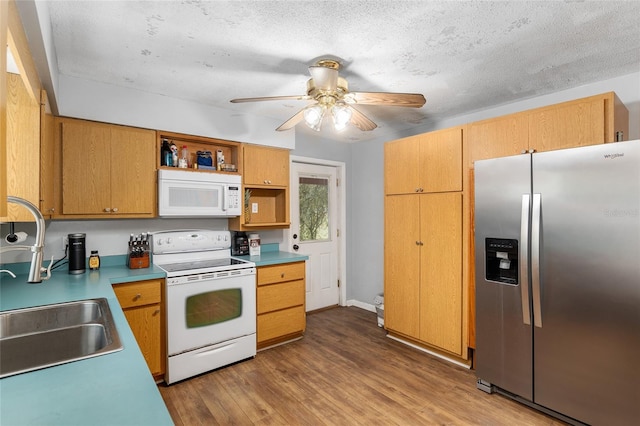 kitchen with white appliances, sink, a textured ceiling, light hardwood / wood-style floors, and ceiling fan