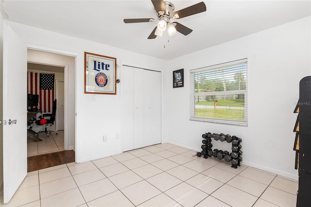 tiled empty room featuring ceiling fan