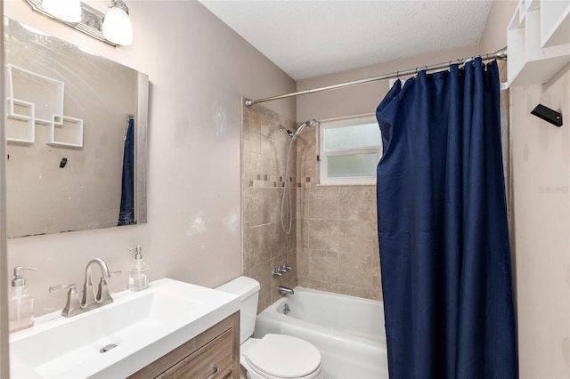 full bathroom with vanity, toilet, a textured ceiling, and shower / bath combo