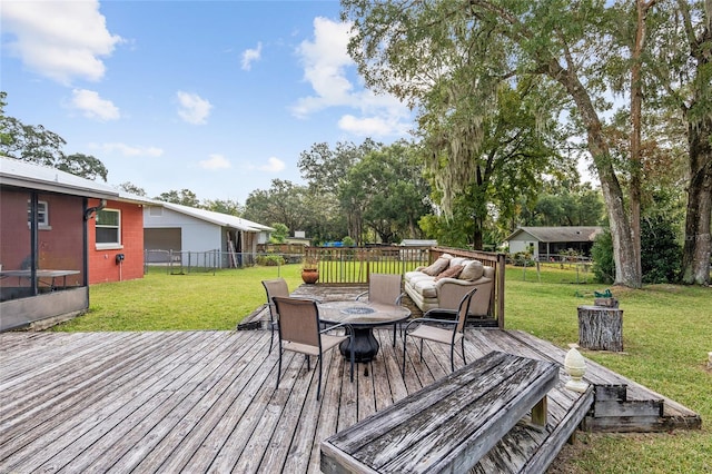 wooden terrace featuring a yard