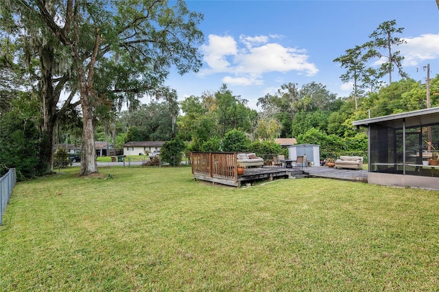 view of yard featuring a sunroom and a deck