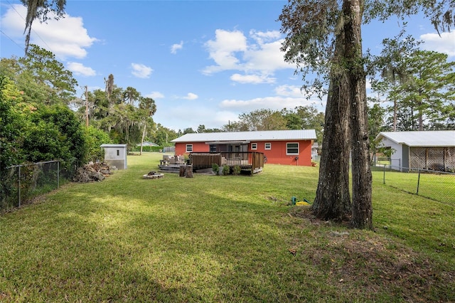 view of yard with a storage unit and a deck