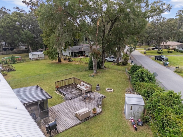 exterior space with a wooden deck and a lawn