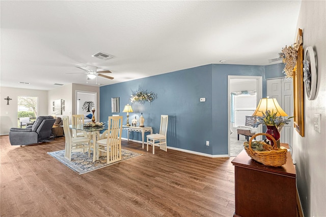 dining space with ceiling fan and wood-type flooring