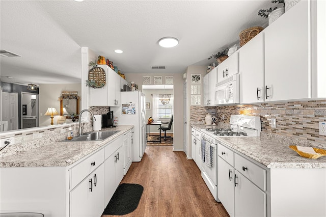 kitchen with light hardwood / wood-style floors, white cabinetry, white appliances, and sink