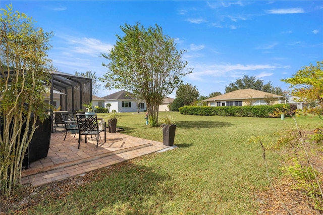 view of yard with a lanai and a patio area