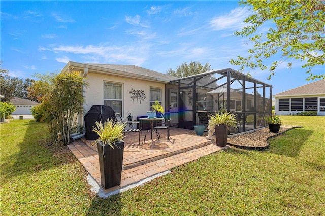 rear view of house with a yard, a patio area, and a lanai