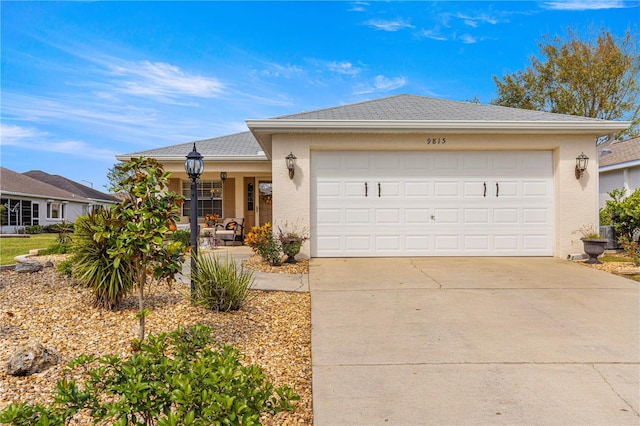 single story home with covered porch and a garage