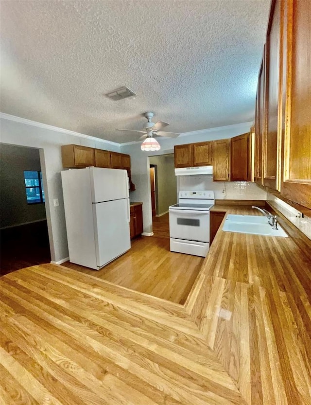 kitchen with white appliances, sink, a textured ceiling, light hardwood / wood-style floors, and ceiling fan