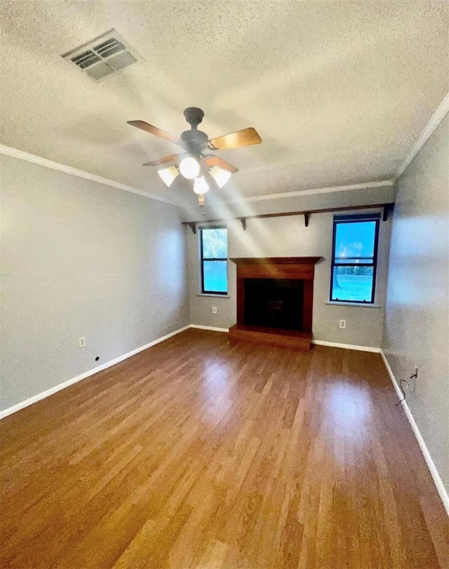 unfurnished living room with hardwood / wood-style floors, crown molding, a textured ceiling, and ceiling fan