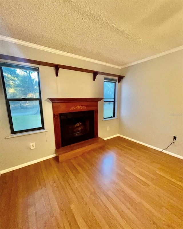 unfurnished living room with crown molding, a textured ceiling, and wood-type flooring