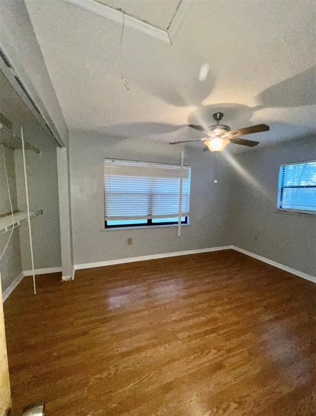 unfurnished bedroom featuring a textured ceiling, dark hardwood / wood-style floors, and ceiling fan